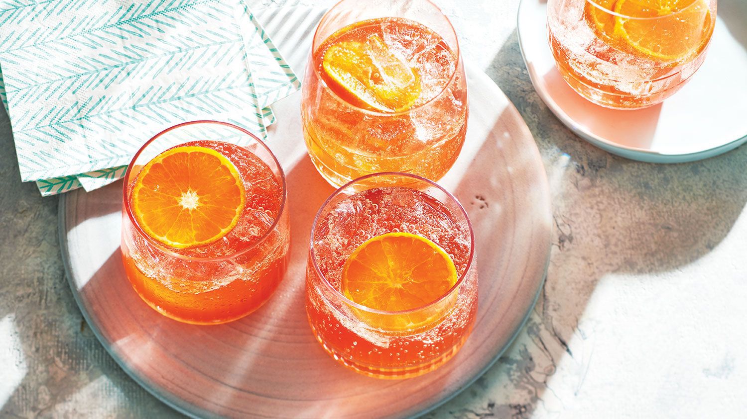 An image shows glasses of mandarin orange mocktail.